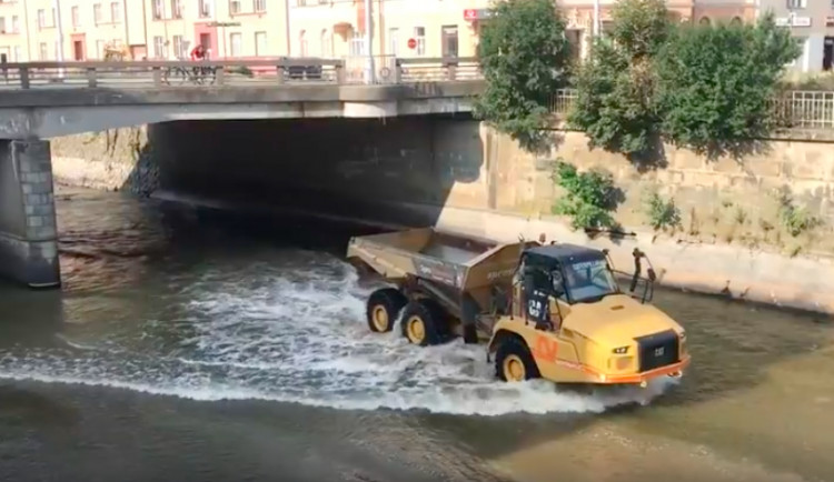 VIDEO: Stavební stroje se brodí korytem Moravy a odvážejí suť ze zbouraného mostu. Podívejte se