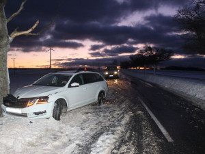 FOTO: Řidič dostal se svým autem na zasněžené silnici smyk a skončil ve stromu